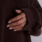 women hand wearing gold rings