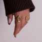 Women hand wearing gold rings
