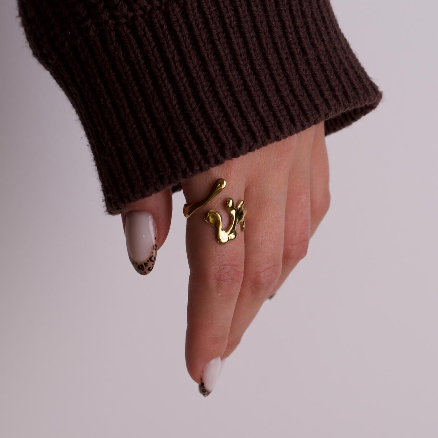 Women hand wearing gold rings