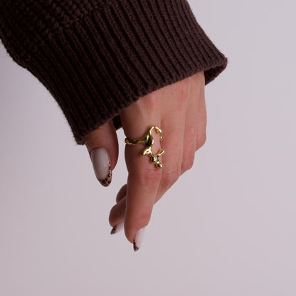 Women hand wearing gold rings